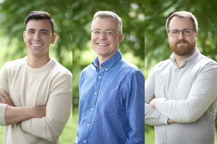 Three men in casual clothing posing for outdoor portrait photos