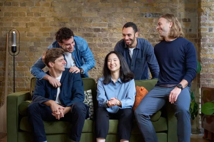 Team members casually posing together in an office environment