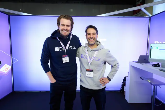 Two colleagues at a business booth during an exhibition event